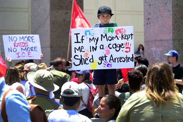People hold placards during a 'Familes Belong Together' march and rally in Los Angeles, California on June 30, 2018 where a thousands turned out to decry the Trump administration's detention of families policy at the US Mexico border. PHOTO | FREDERIC J. BROWN | AFP